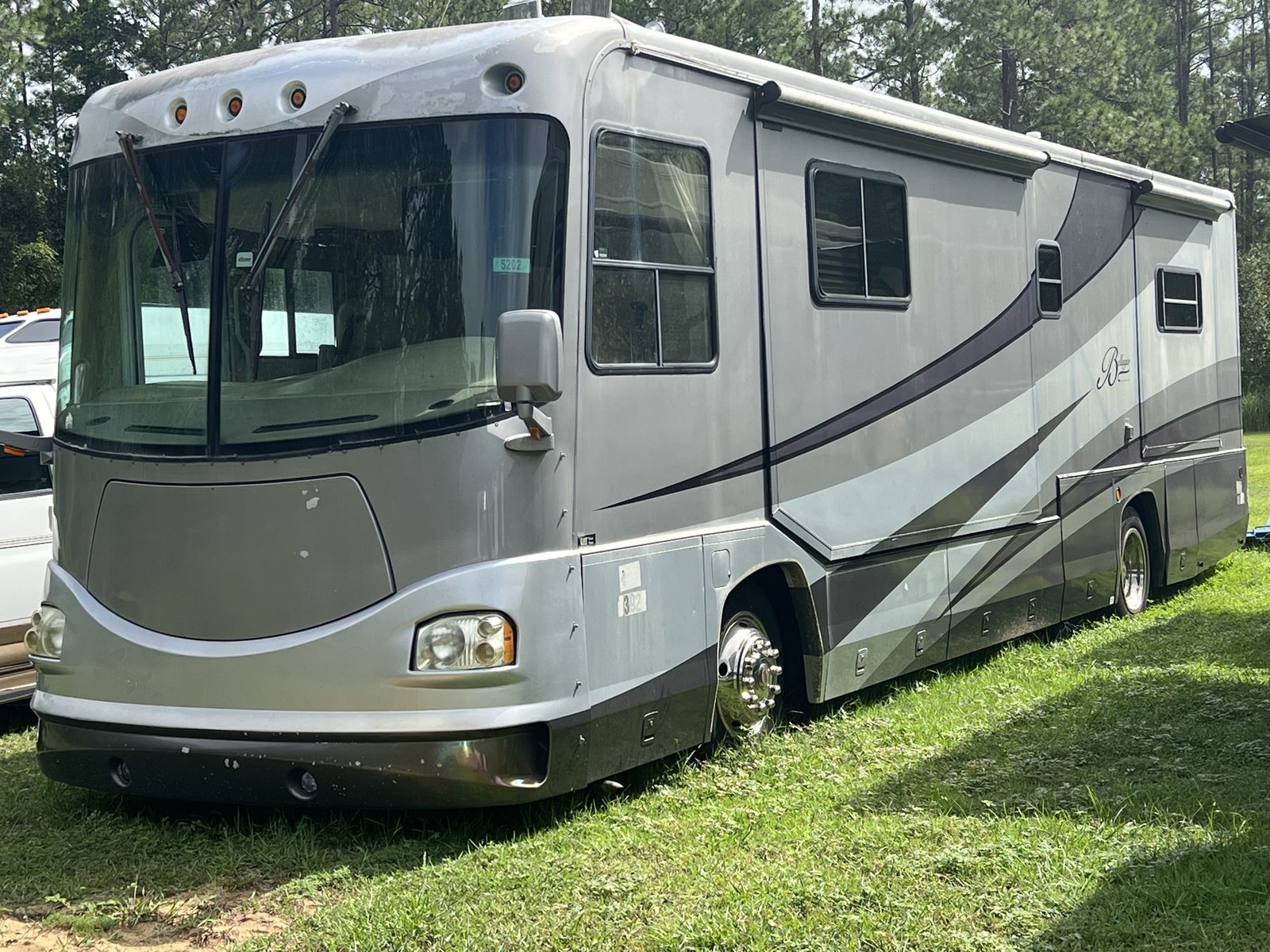Beaver Class A diesel motorhome purchased for cash on a grassy roadside lot