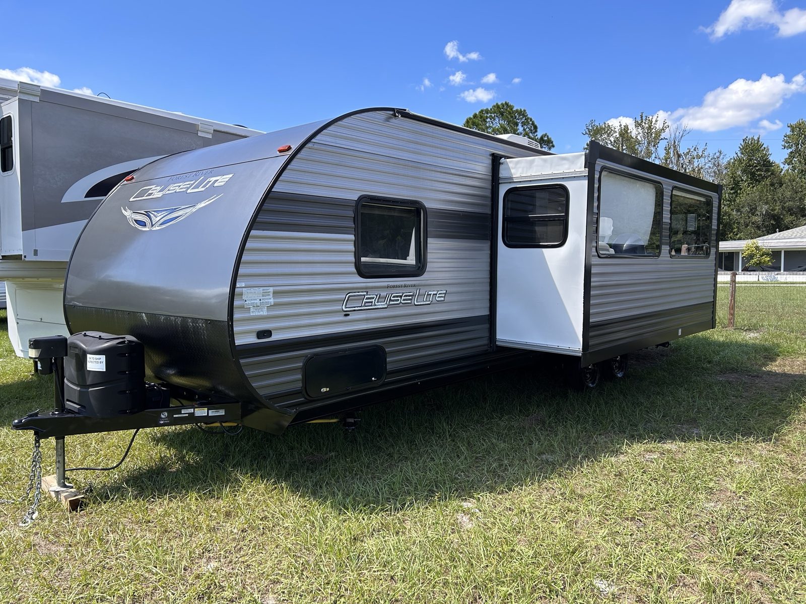 Cruise Lite travel trailer next to a fifth wheel