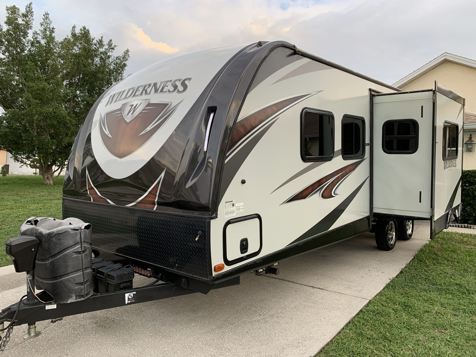 Wilderness travel trailer by Heartland in a driveway